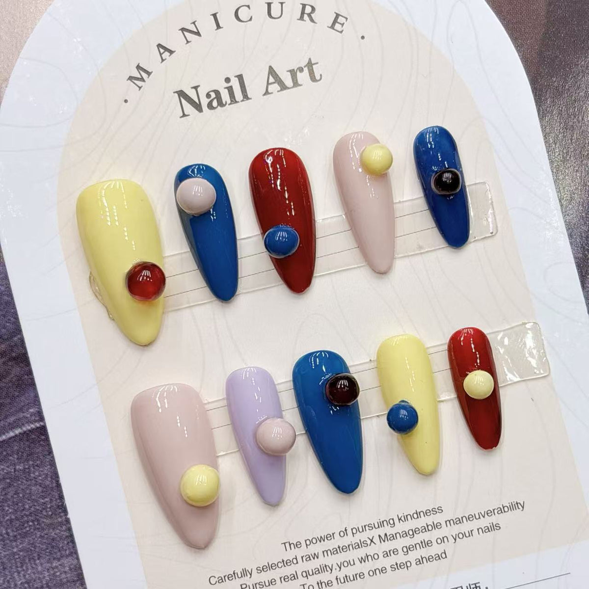 NailFilck Color Pop Bubble 3D Press-On Nails with tapered shape, glossy red, blue, yellow, pink and lavender nails with raised bubble accents